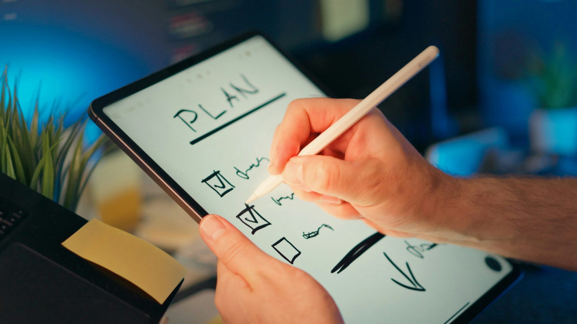 Someone is writing a plan on a tablet.